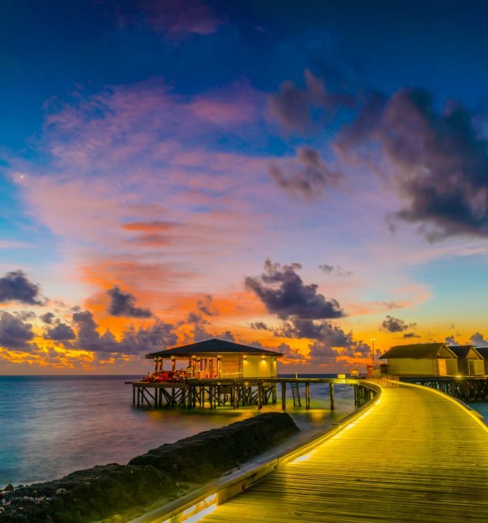 Beautiful water villas in tropical Maldives island at the sunset time